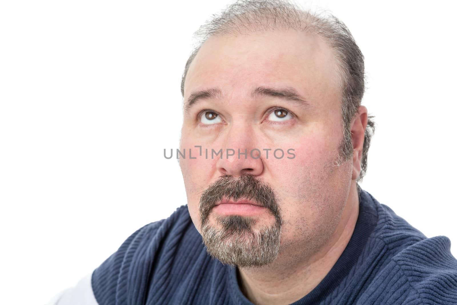 Close-up portrait of a mature man thinking in a serious expression