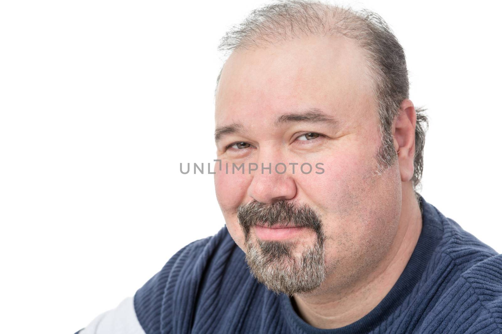 Close-up portrait of a mature man smiling and squinting the eyes