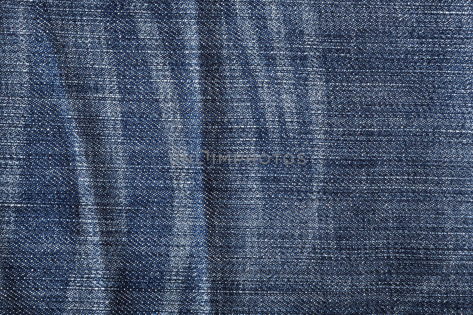 The worn blue jeans, a textile background