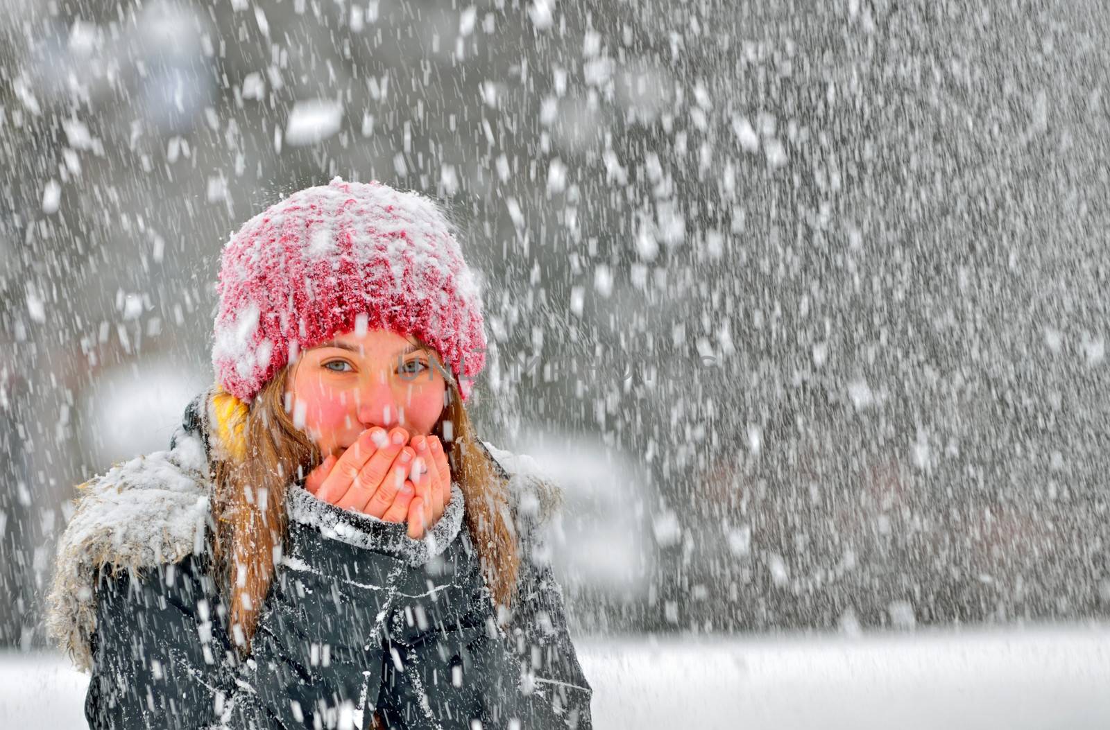 freezing young woman warming his hands
