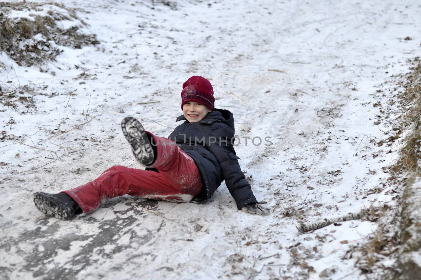 the teenage boy rides from a hill in the snow-covered wood