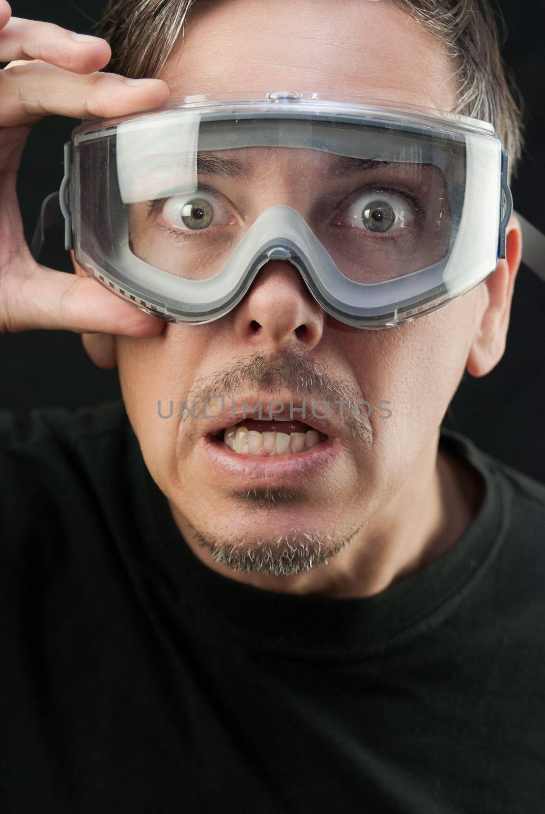 Close-up of a crazy man wearing goggles.