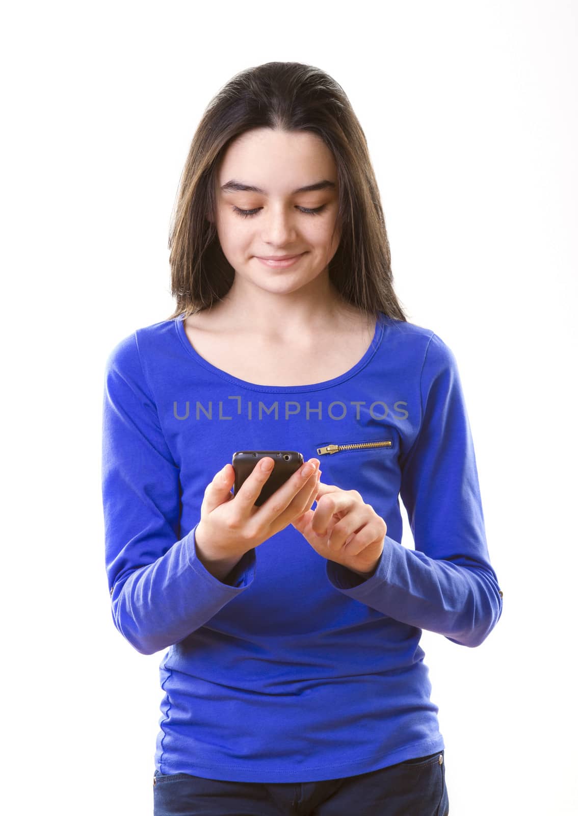 Teenage girl with smartphone on white background.
