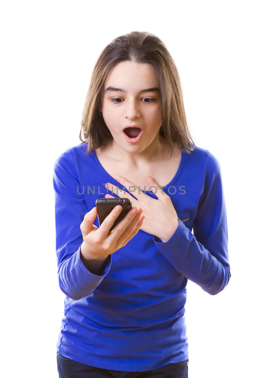 Surprised teenage girl with smartphone on white background.