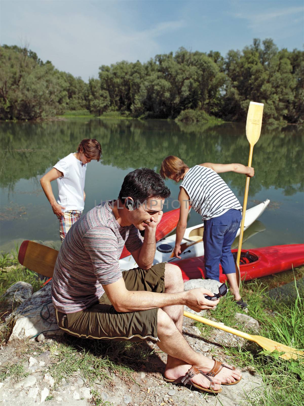 men with canoe in nature