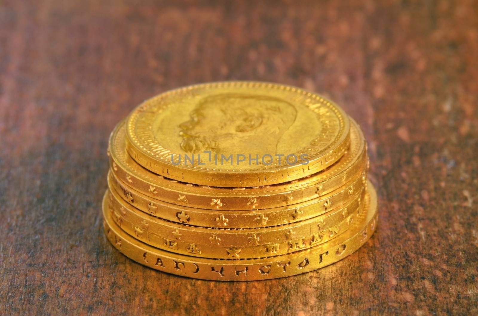 Golden old coins stack. Russian and swiss gold. Focus on nearest edge,