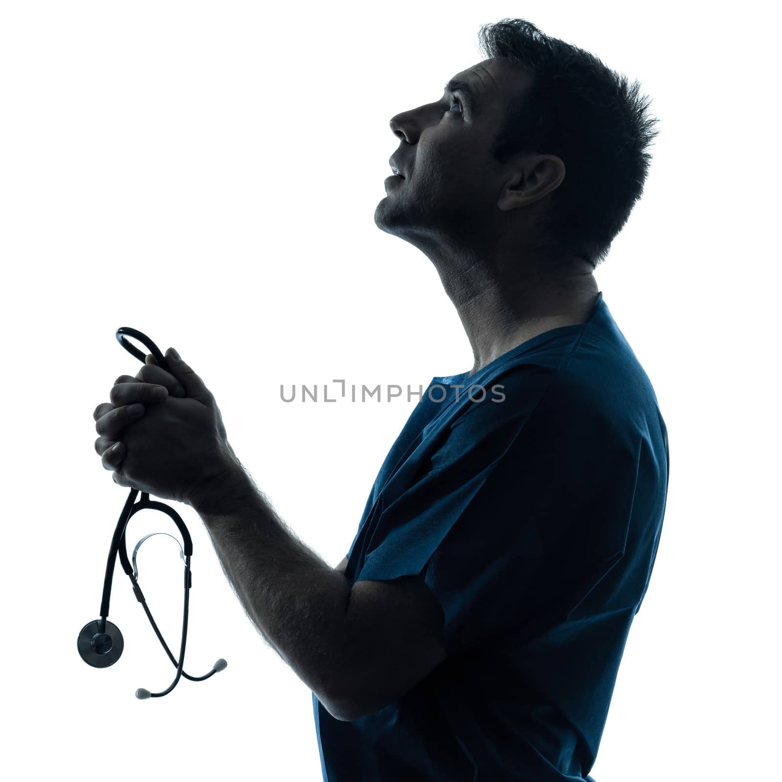one caucasian man doctor surgeon medical worker praying silhouette isolated on white background