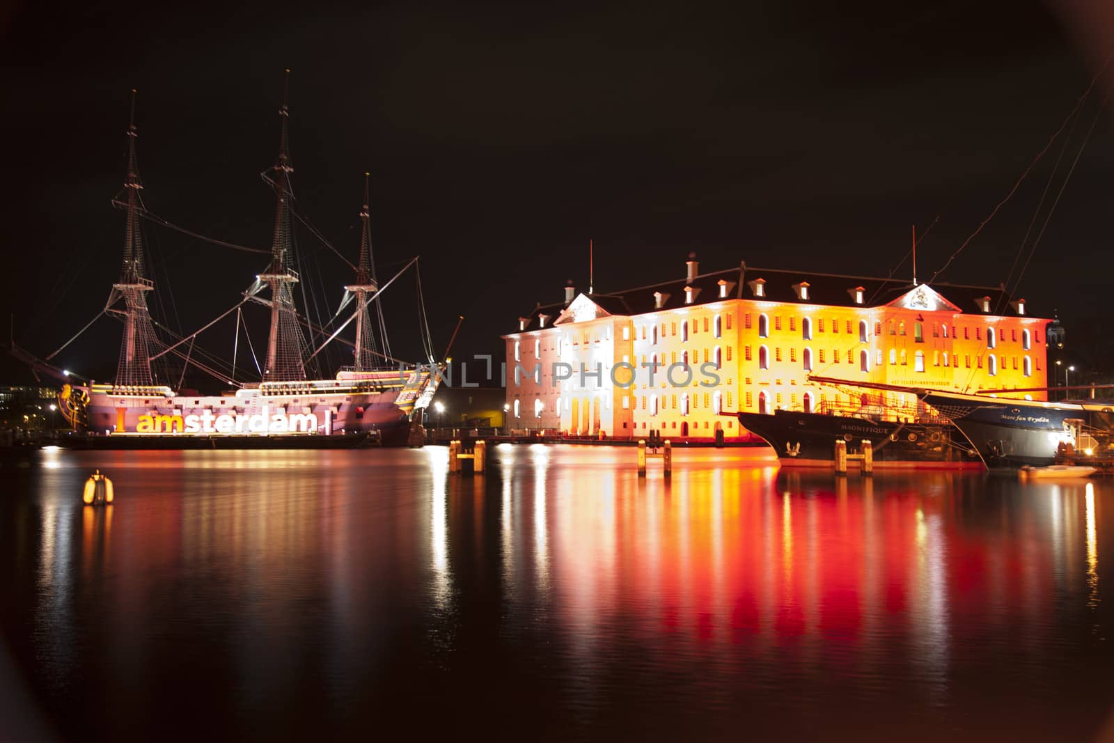 AMSTERDAM, THE NETHERLANDS: Building and ancient ship with lights at annual Amsterdam Light Festival on December 30, 2013. Amsterdam Light Festival is a winter light festival  