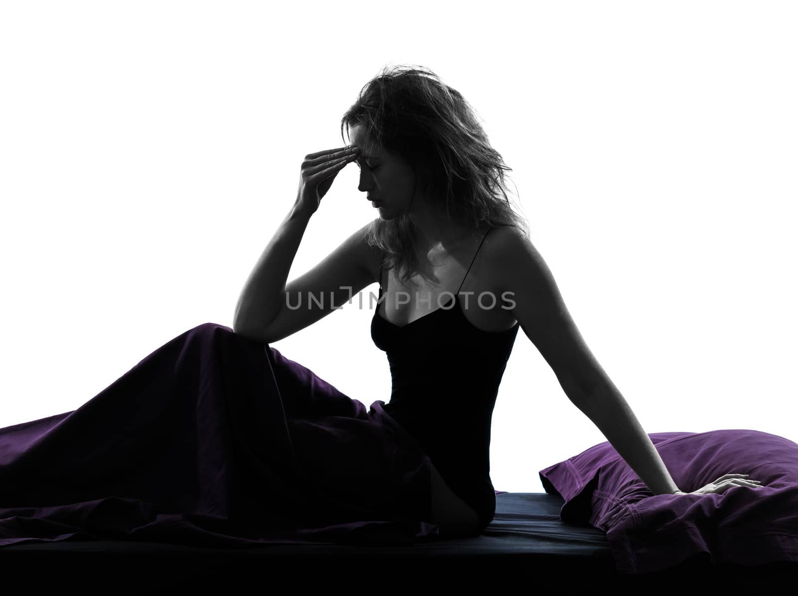 one woman headache hangover sitting on bed silhouette studio on white background