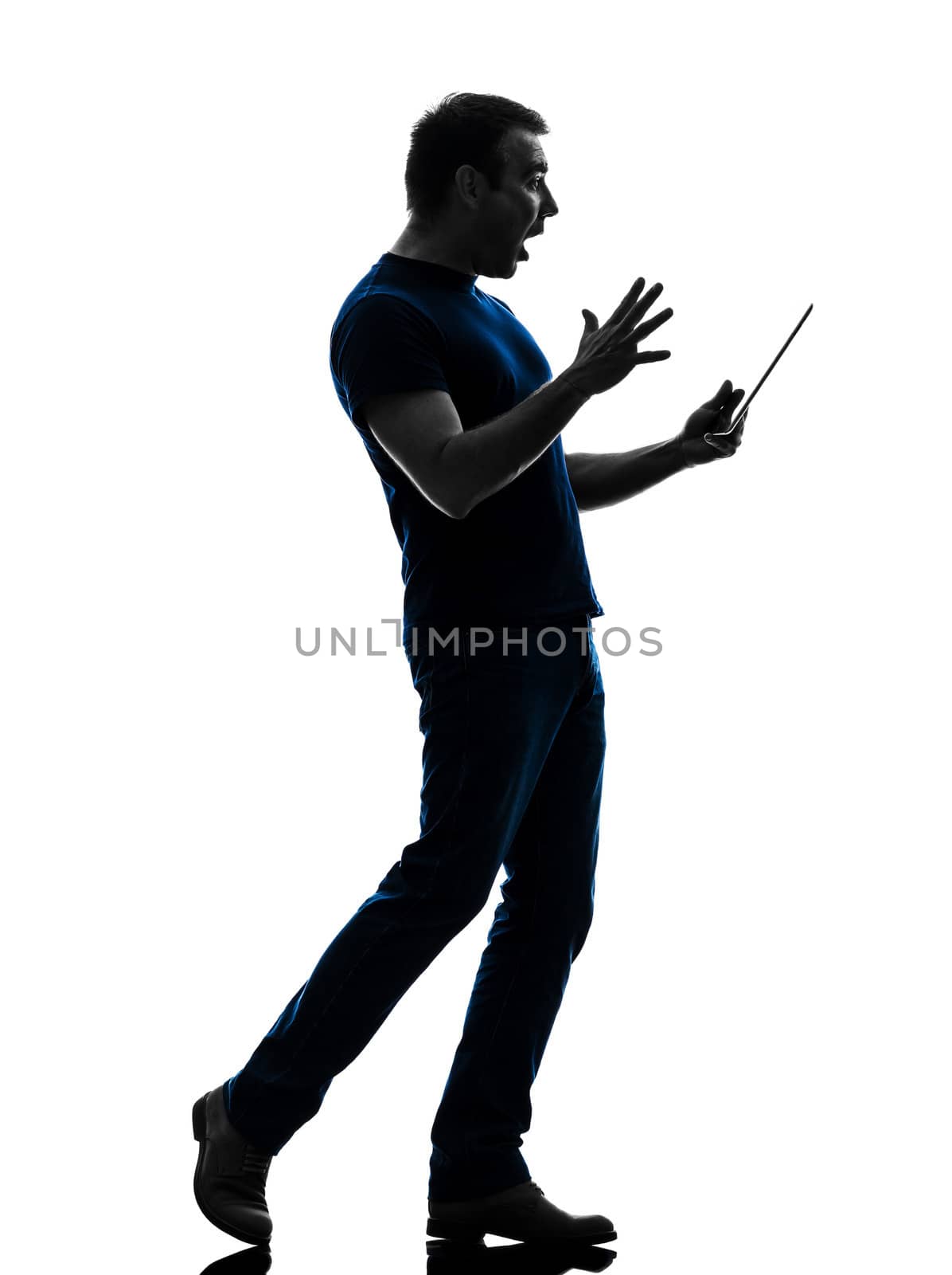 one caucasian man holding digital tablet surprised in silhouette on white background