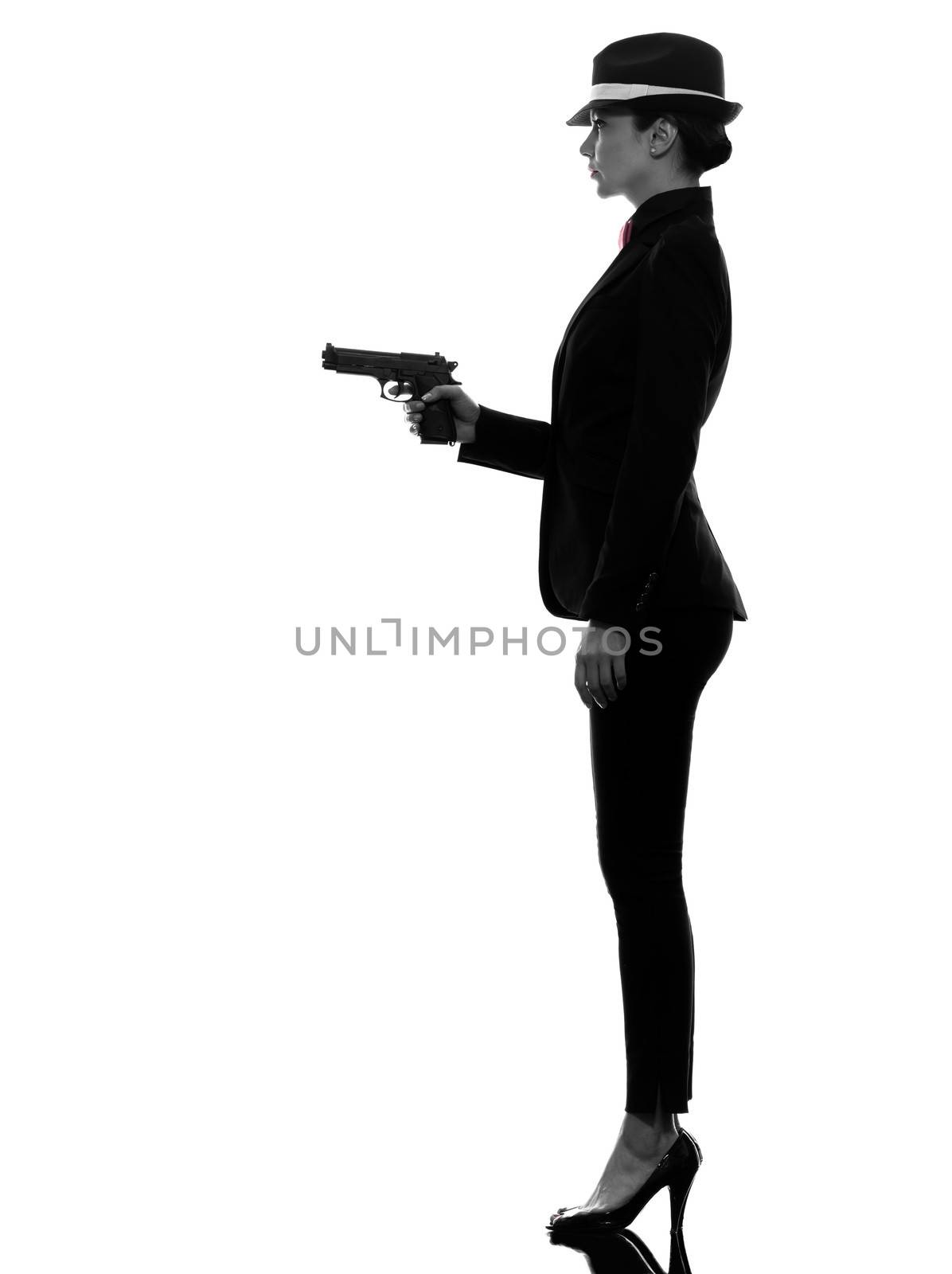 one stylish caucasian woman in suit holding gun in silhouette on white background