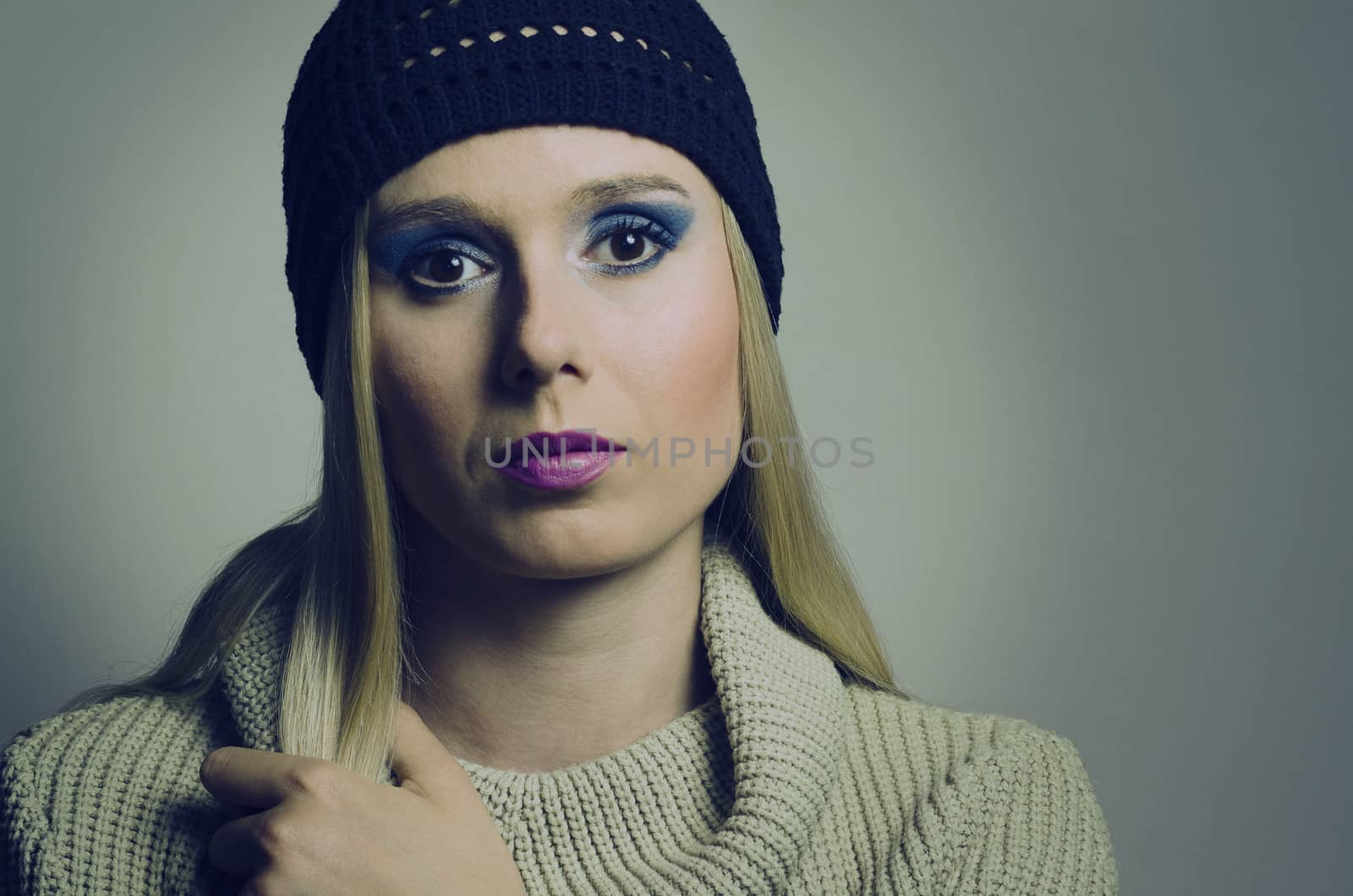 fashion portrait of a blond woman wearing a turtleneck and a hat by Grufnar