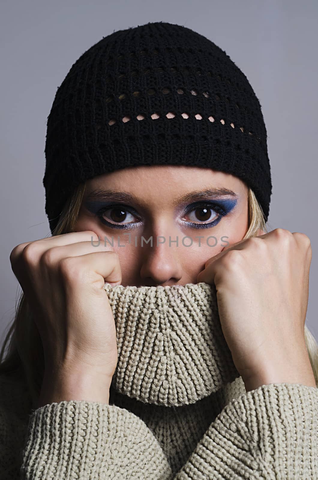 blonde woman covering her face with turtleneck vertical by Grufnar