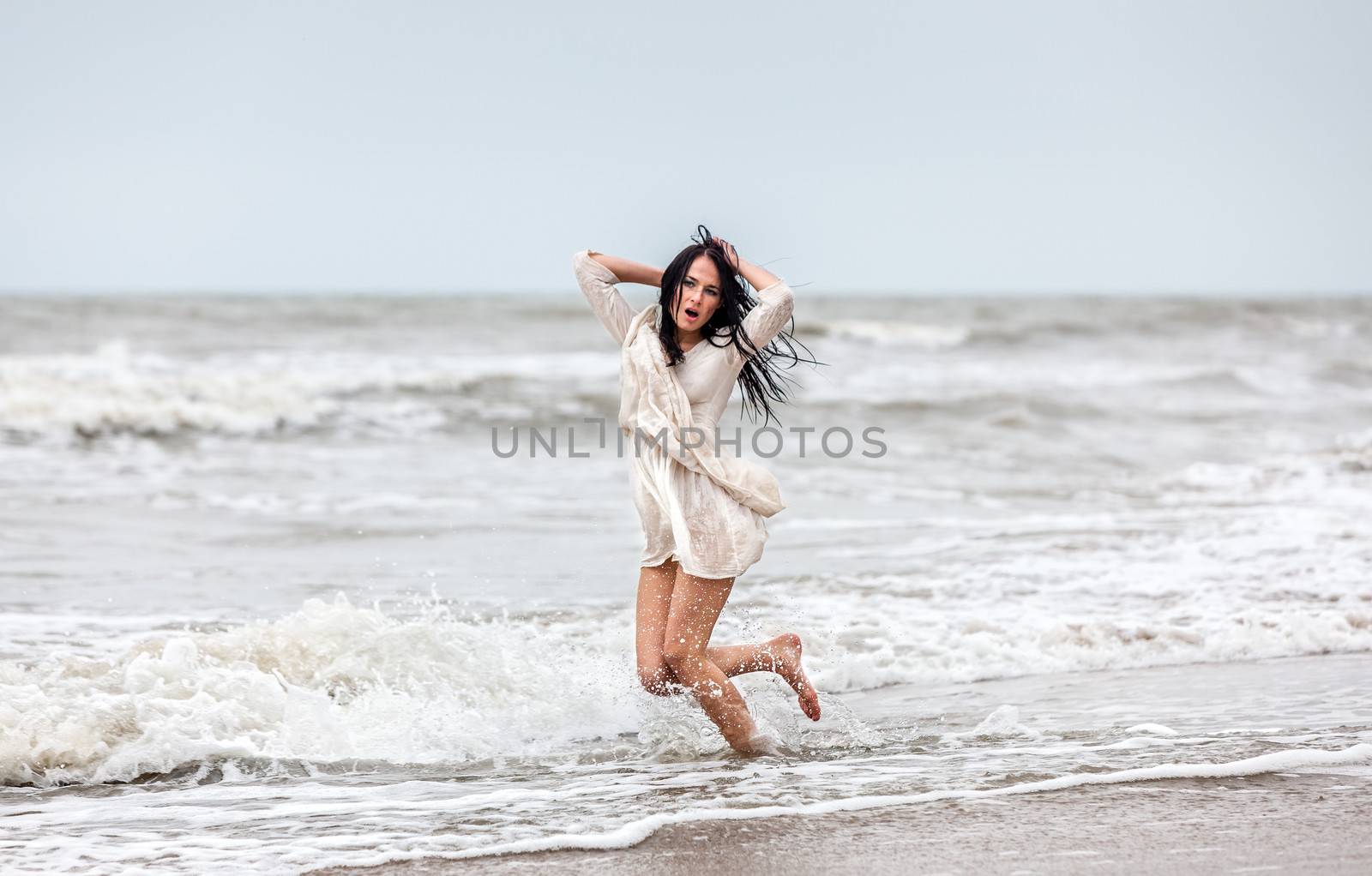 seminude woman in the cold sea waves by palinchak