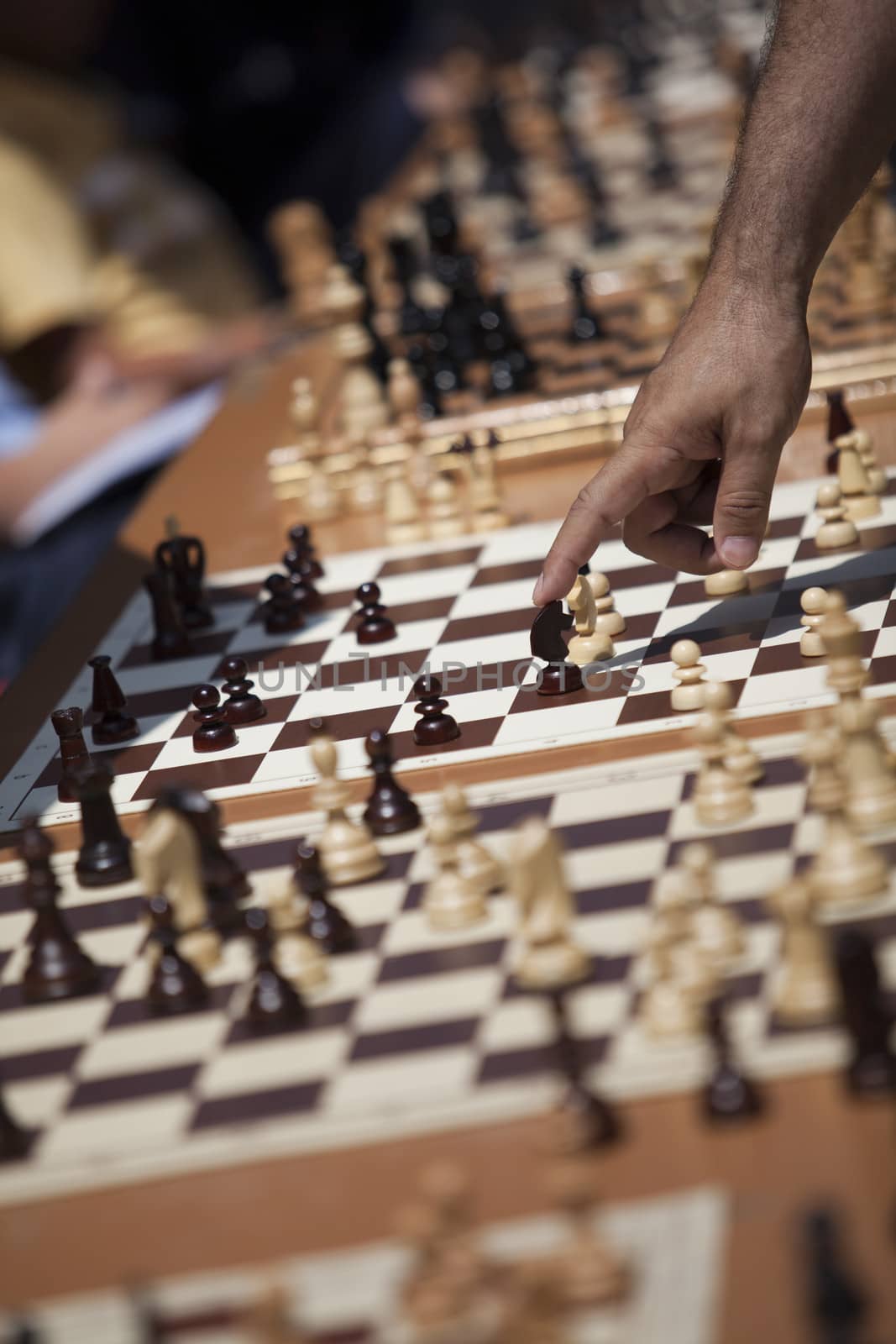 Man playing chess, making the move