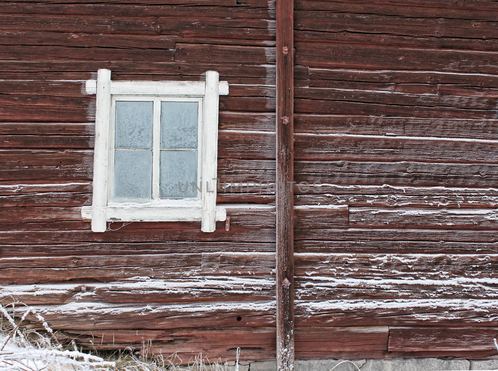 Frosty window of old log home, winter season background