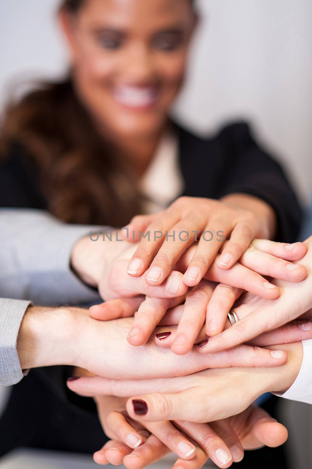 Business team stacking hands by stockyimages