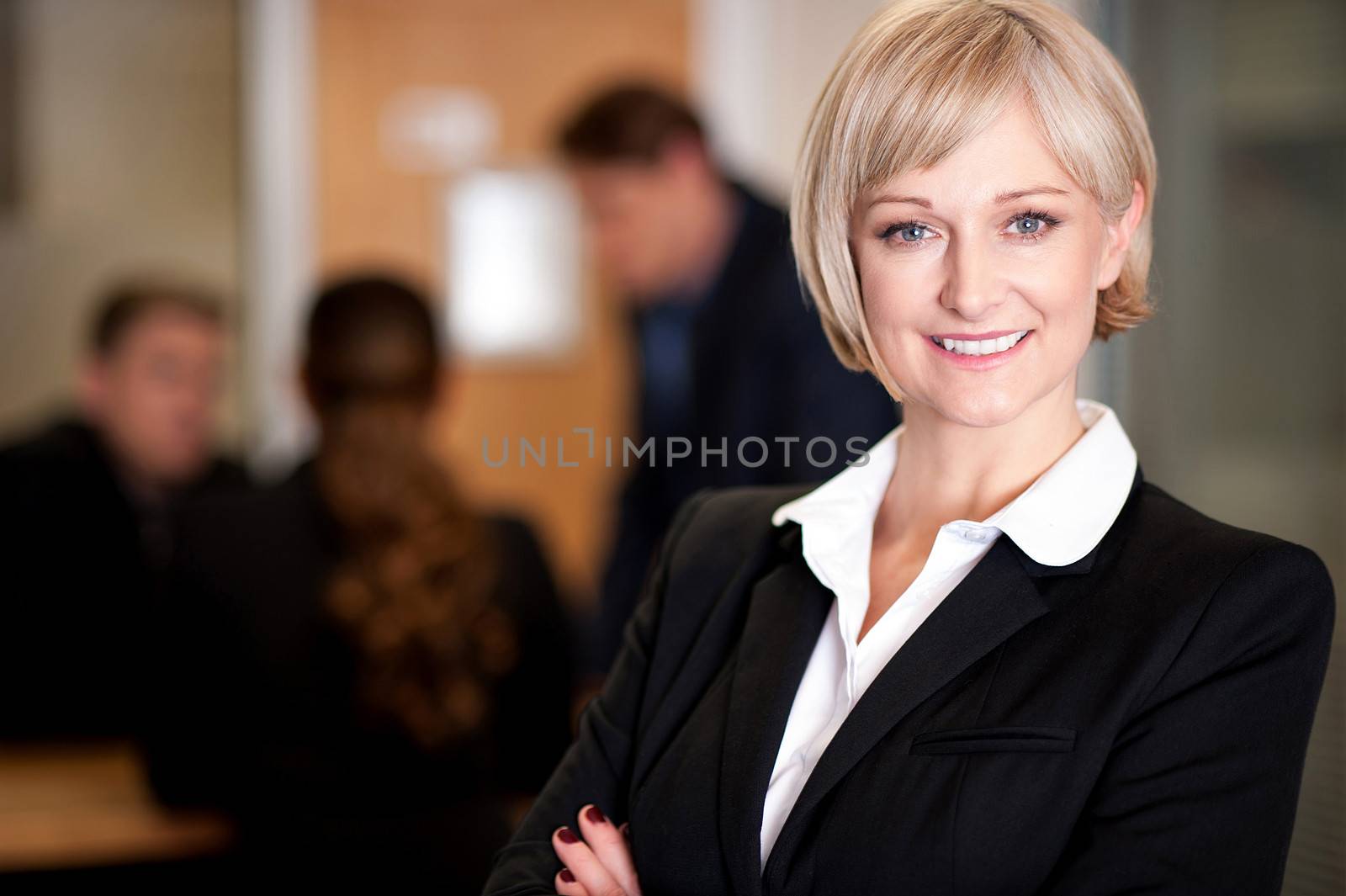 Business team at work, manager in foreground by stockyimages