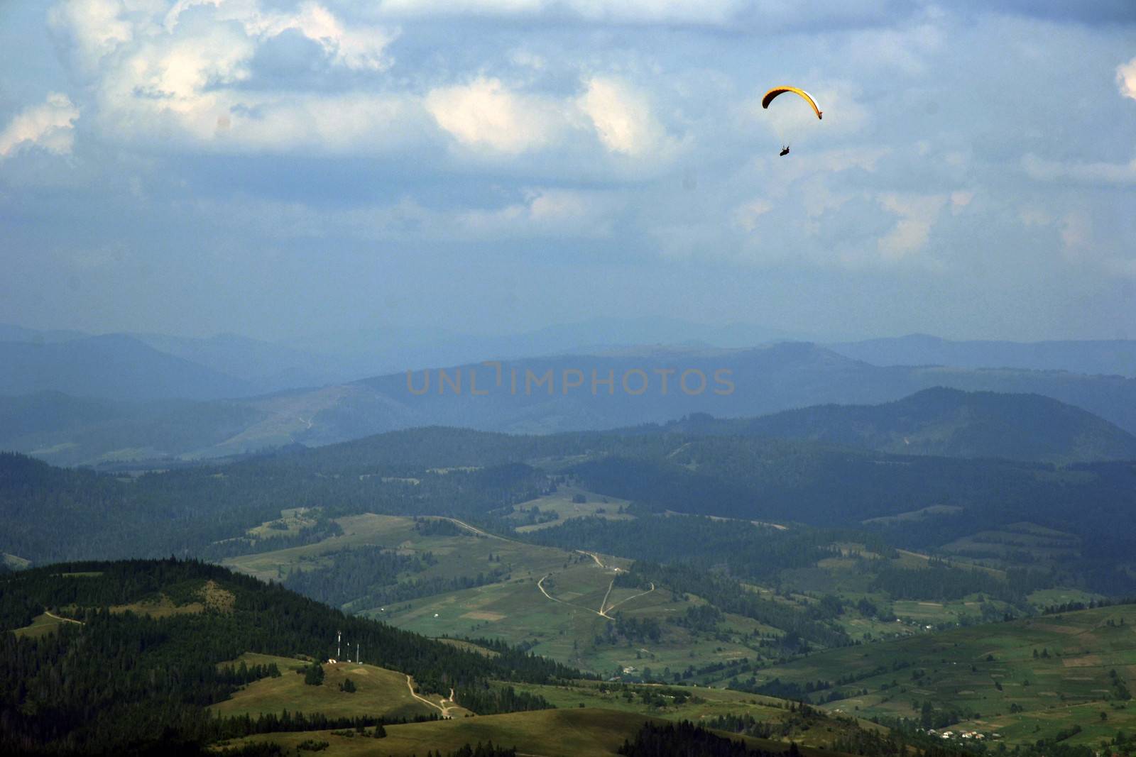 paraglider in the mountains above the village
