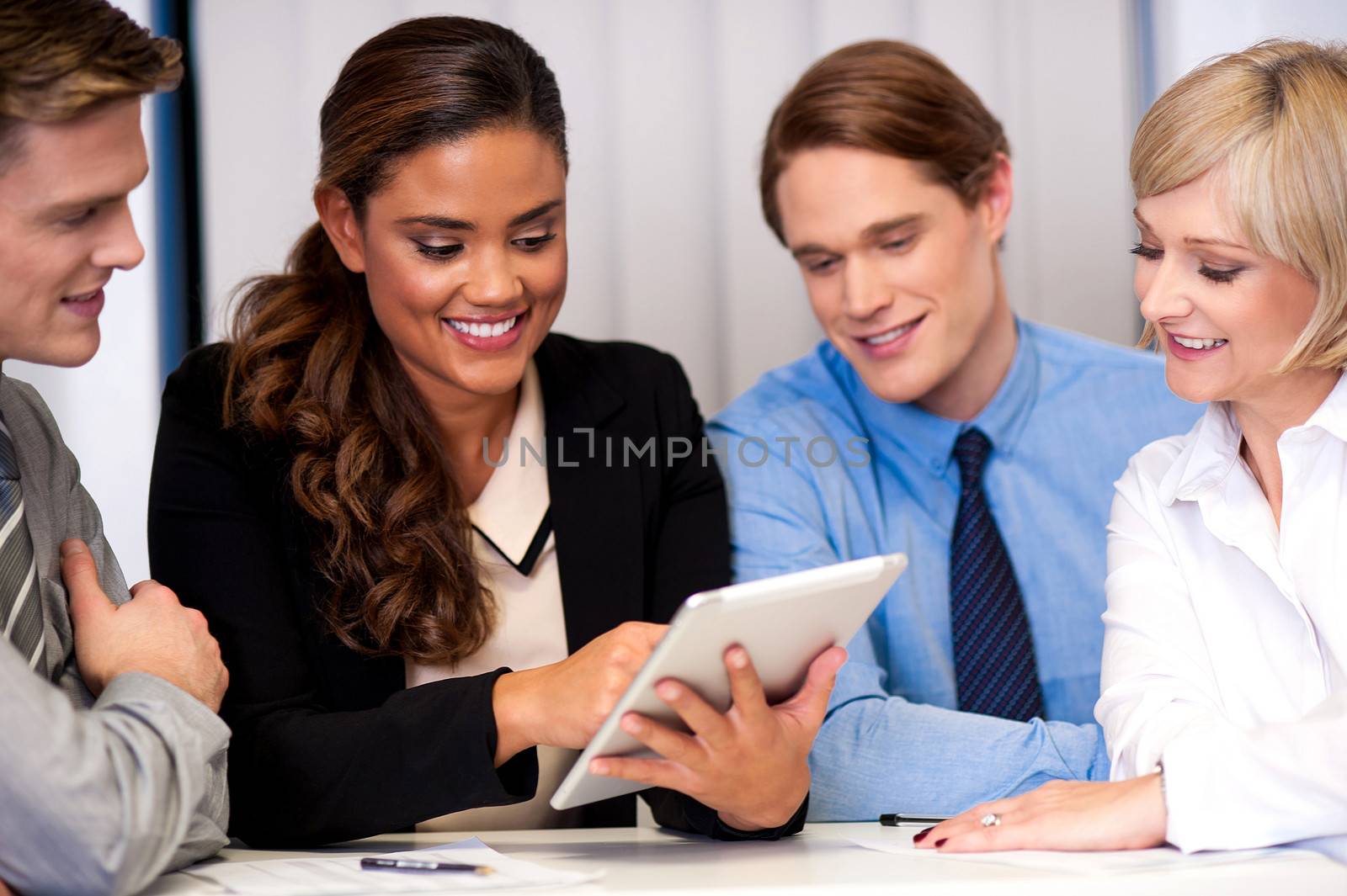 Business team of four enjoying work by stockyimages