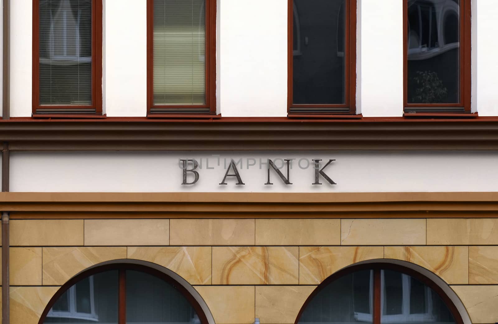 Small branch bank facade detail. No logo, only BANK letters.