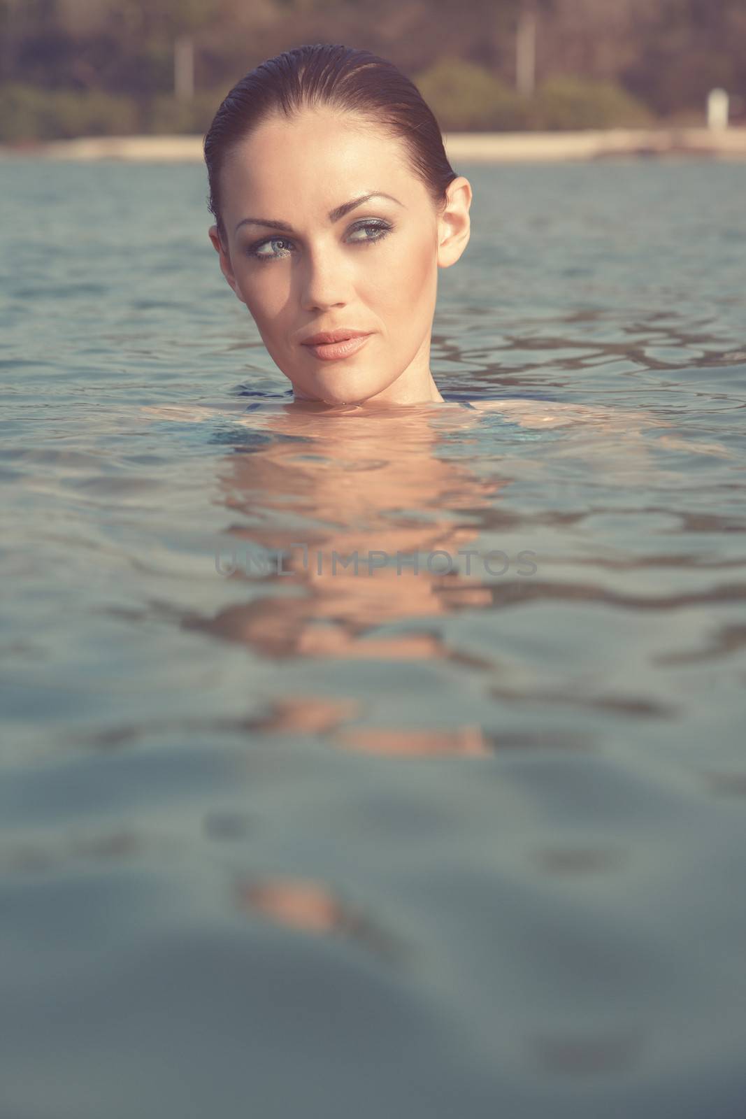 Head of the woman swimming at the summer beach