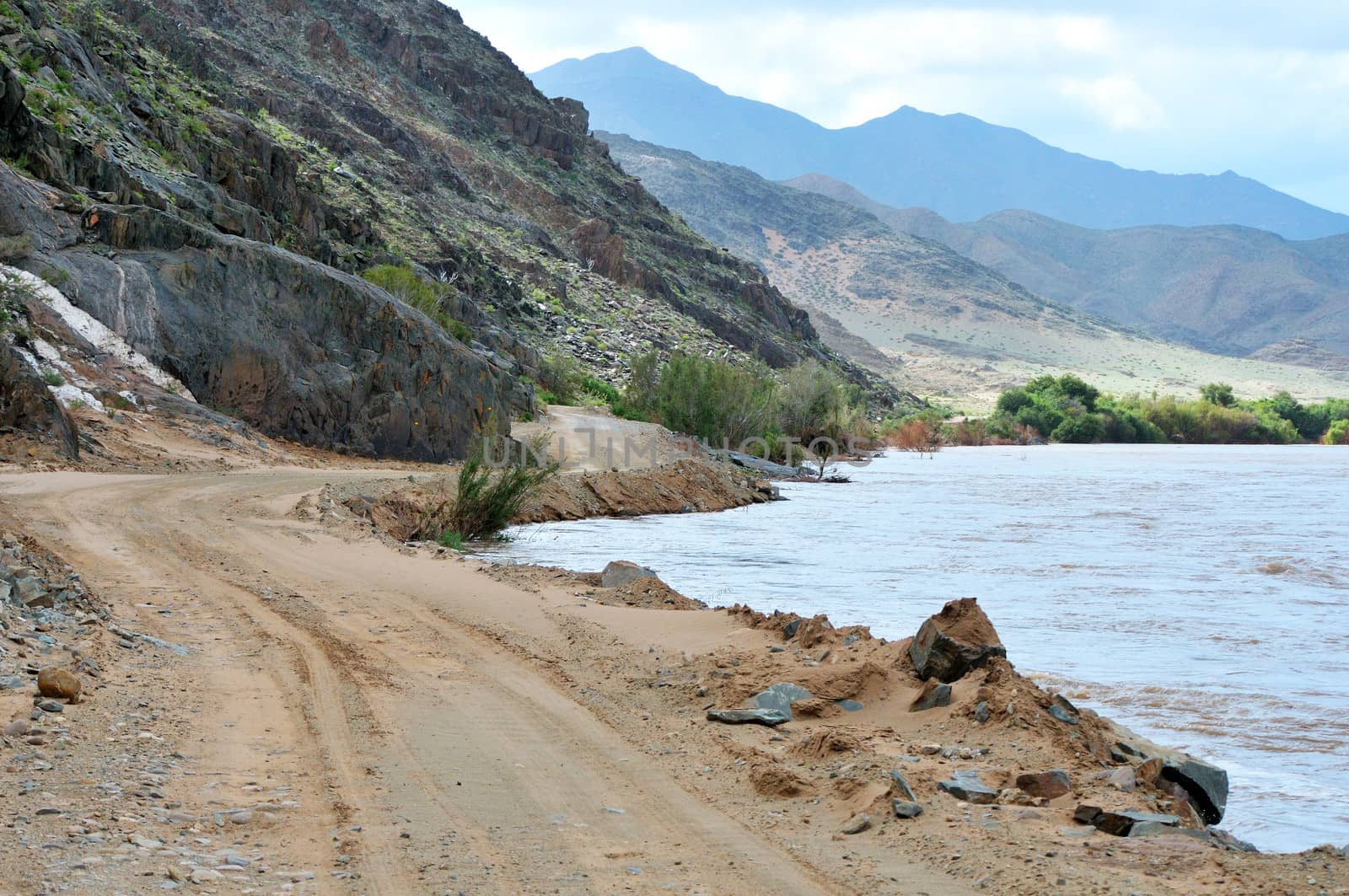 Scenic C13 route in Namibia along a flooded Orange River on the border with South Africa