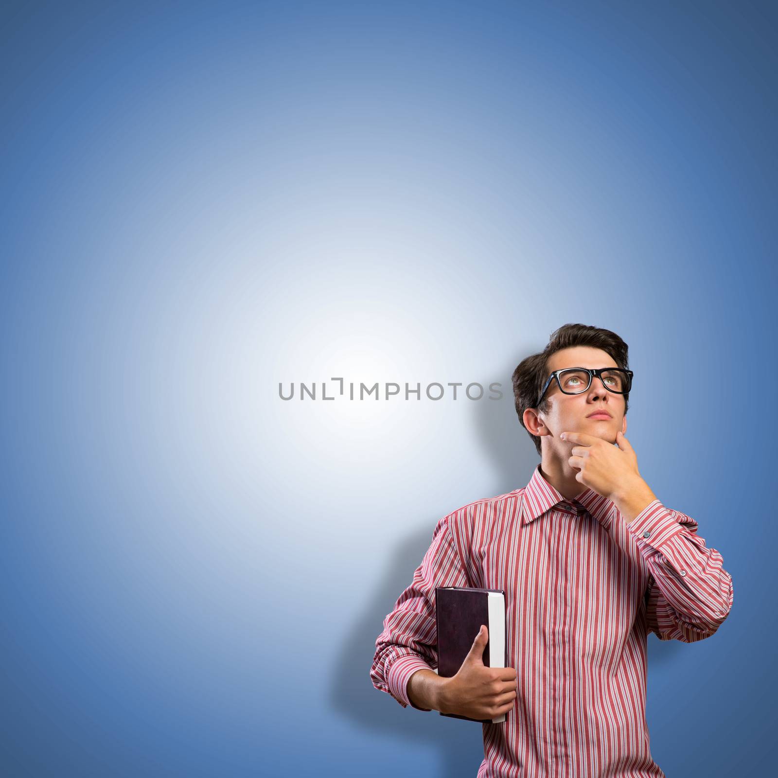 young man scientist in glasses thinking, looking up