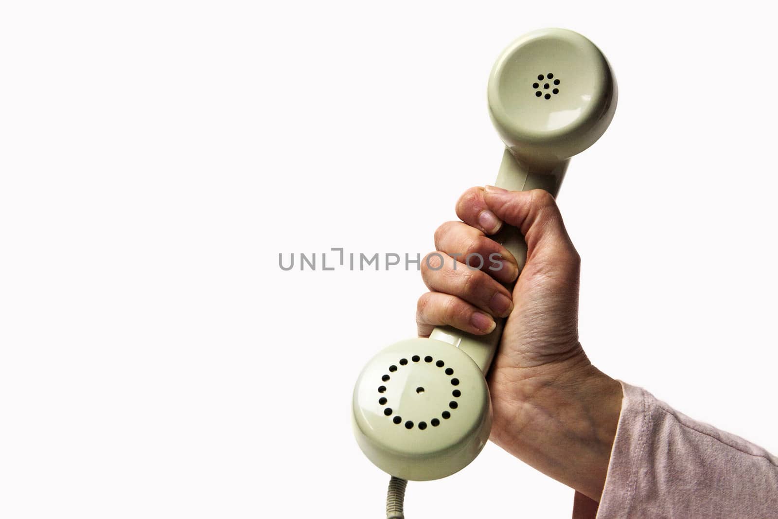 Hand holding a light green retro phone isolated on white background