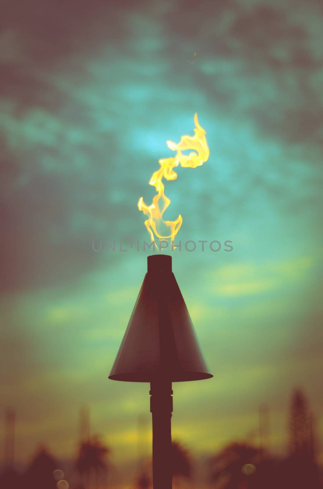 Retro Filtered Vacation Image Of A Hawaiian Tiki Torch At Sunset