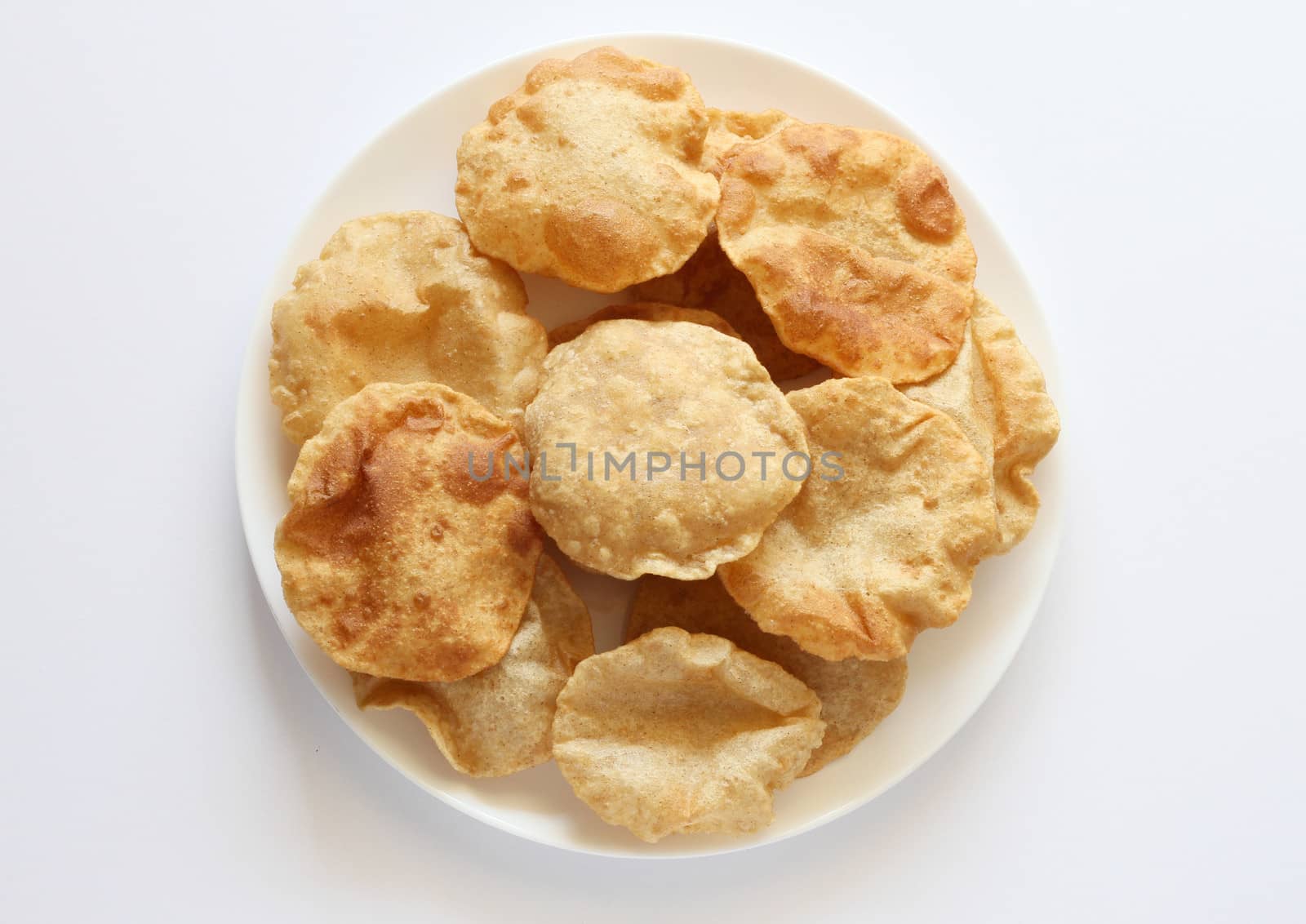 Indian breakfast poori (boori) in a plate with white background by pbsubhash