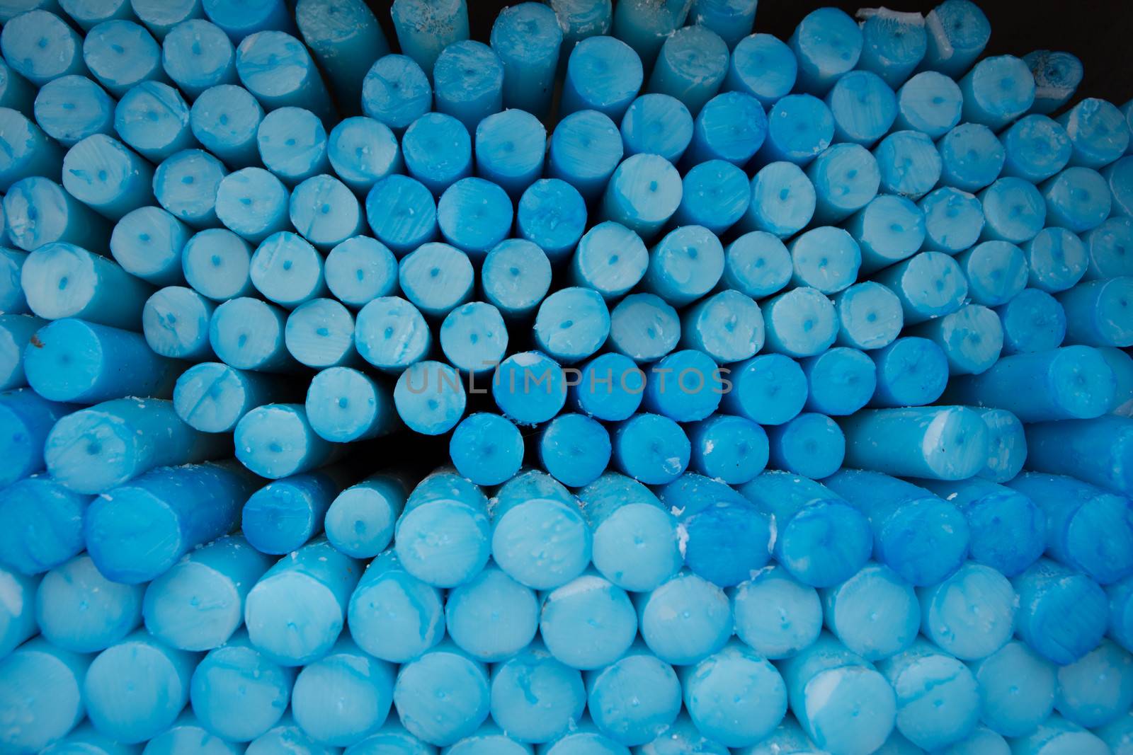 Close up of a group of blue circle candles in Lourdes in France. The Lourdes Sanctuary offers you the possibility of leaving and lighting a candle at the Lourdes Grotto