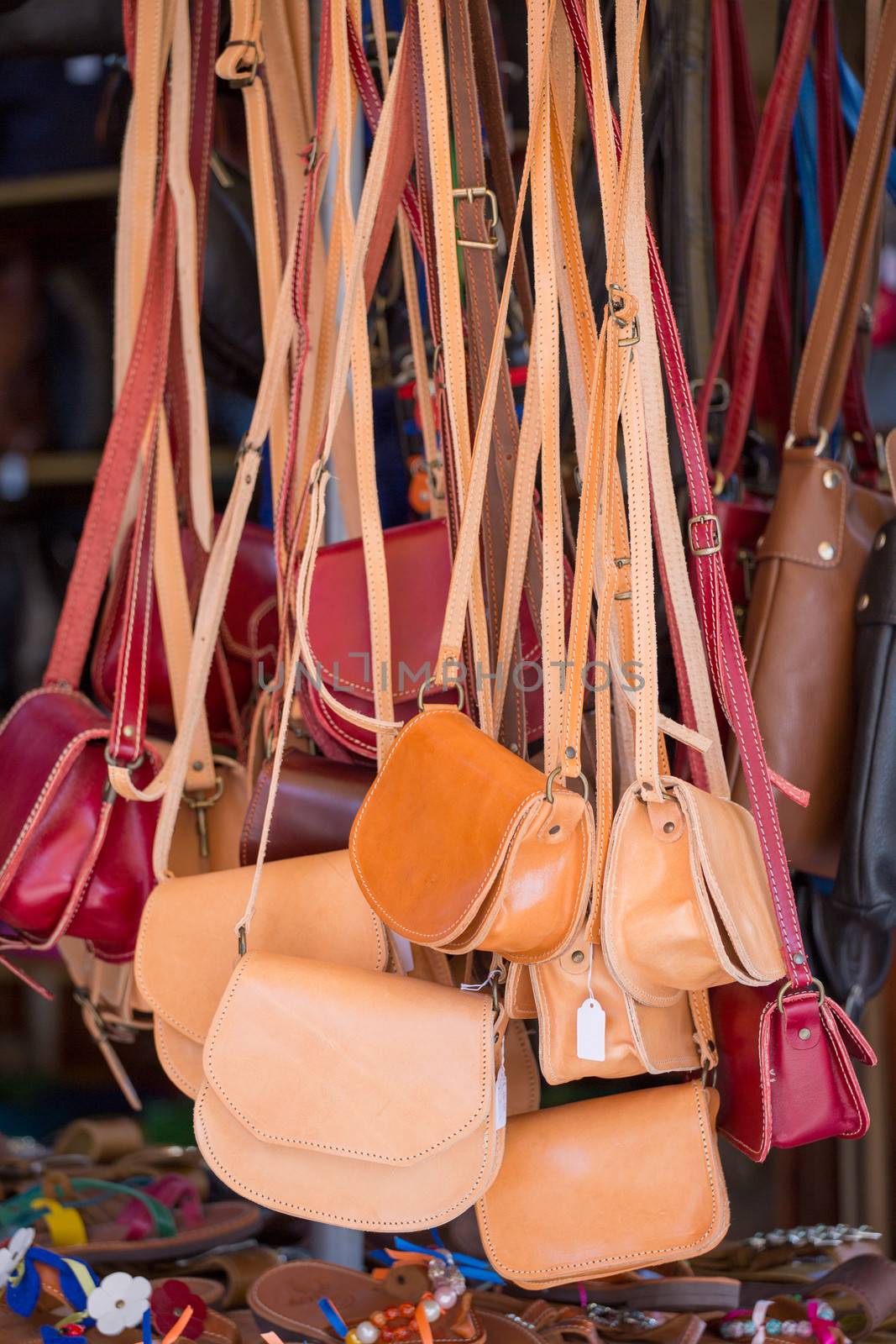 Brown and red Handbags in a local shop  by watchtheworld