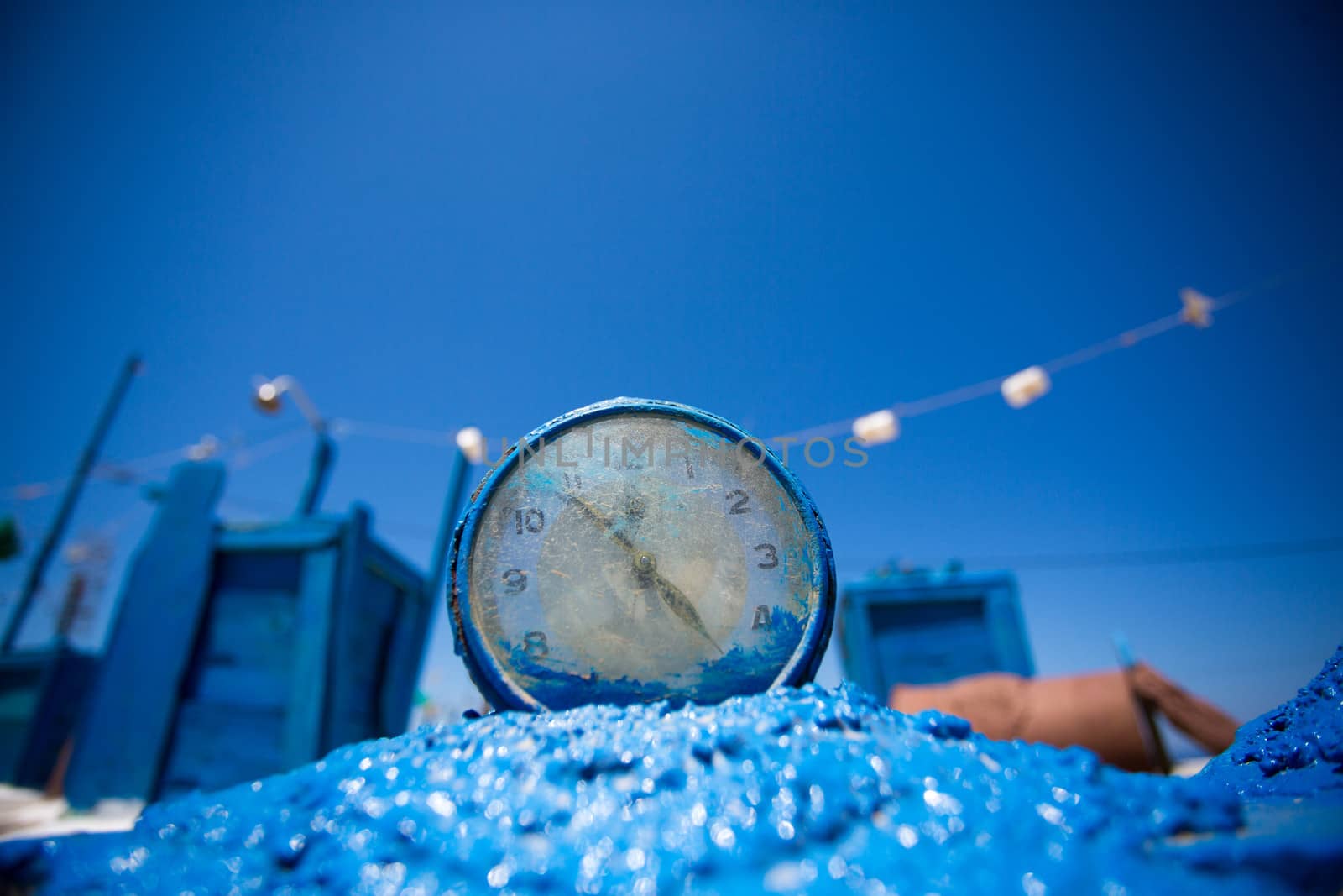 Close up of A clock in the  typical greek color blue, art installation in blue on the beach of Folangandros, Greece, 2013.
