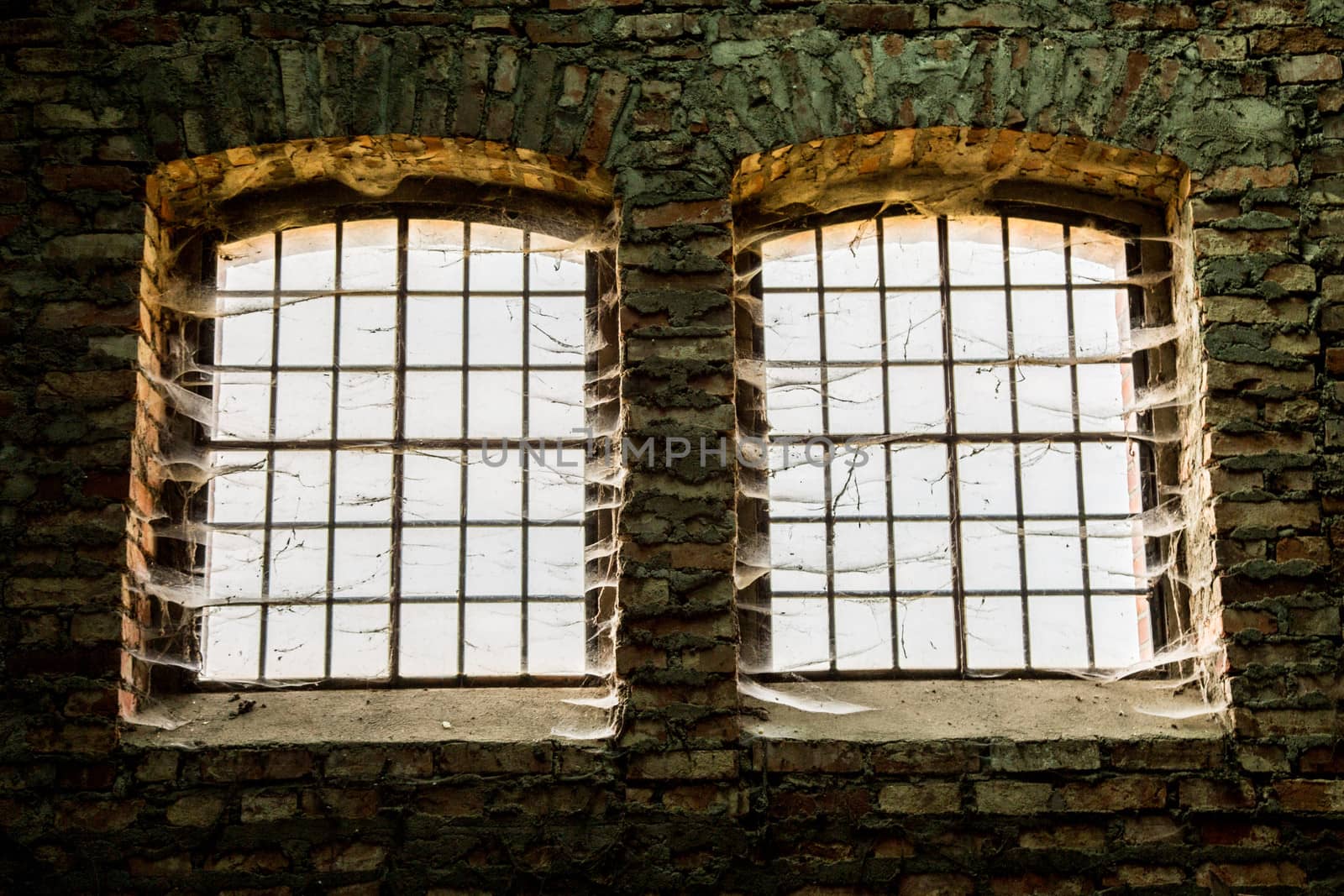Old destroyed windows with old iron bars