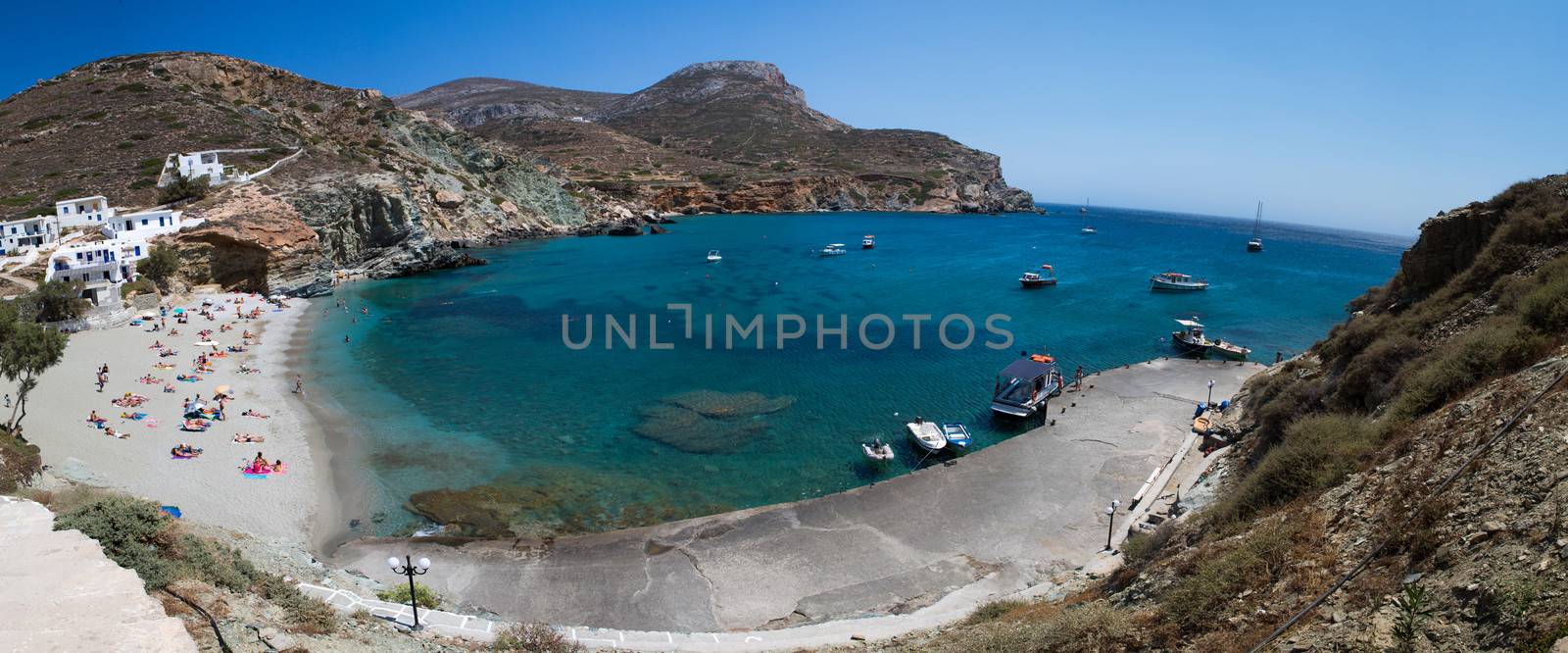FOLEGANDROS, GREECE, JULY 21: Unidentified Tourist laying in the hot afternoon sun at the beach in the harbor on the aegean sea in folegandros, Greece, 2013.