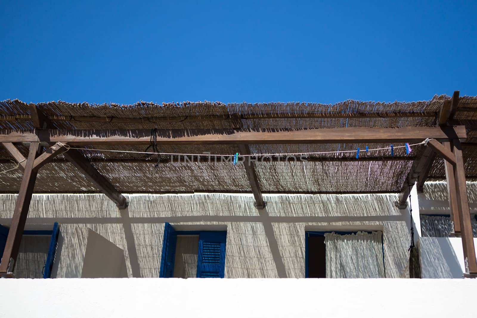 Typical traditional white and blue  facades, In most of the Cycladic islands, houses were painted white to reflect the harsh summer sun. So, it started for let's say "bioclimatic" or "ecological" reasons, to make houses a little more heat resistant, Greece , 2013.