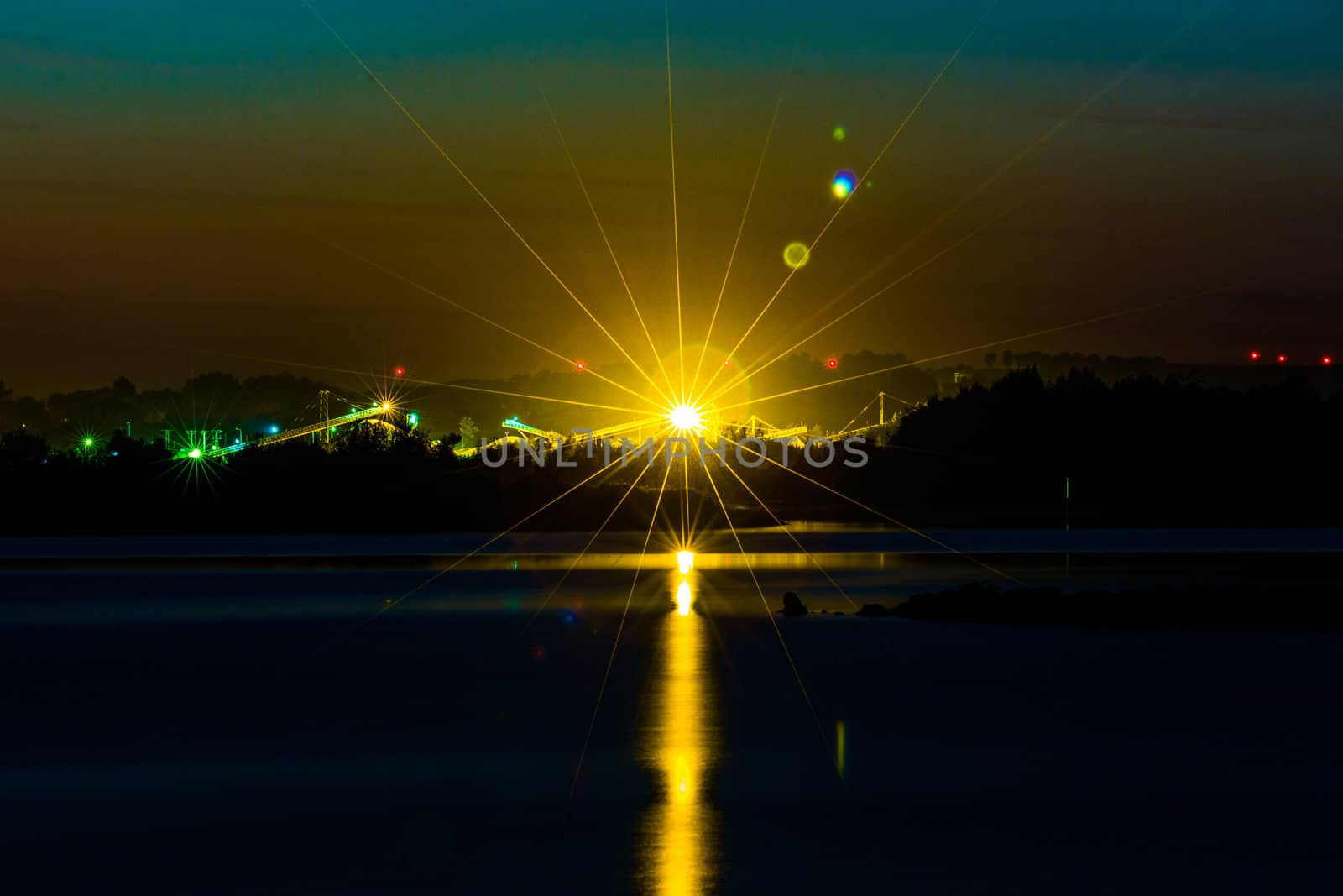Great radiant sunset over the calm lake