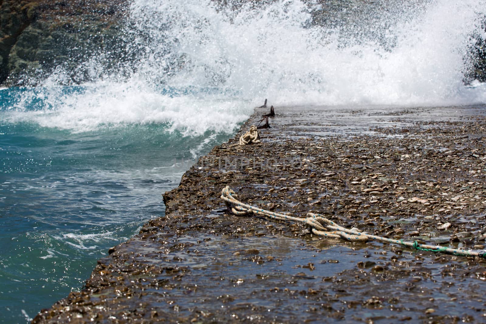 Waves slamming into the rocky coast line in Folegandros, view of the shoreline, the aegean sea  and the rocky mountains, an amazing island from Greece 2013.