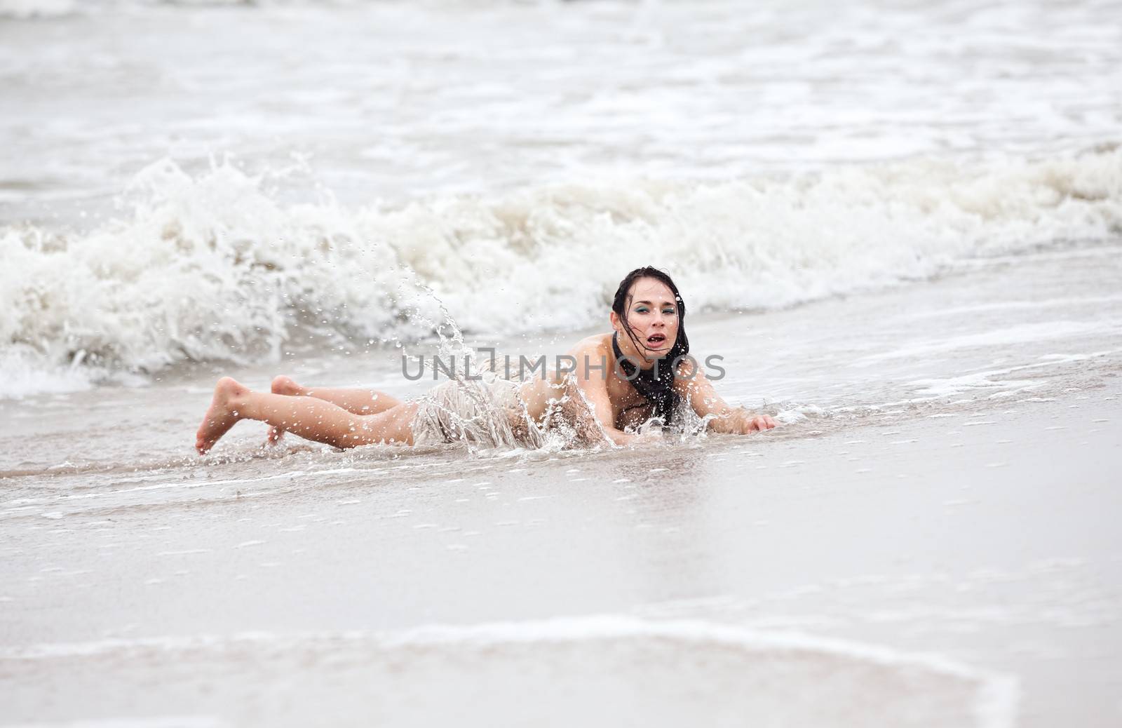 seminude woman in the cold sea waves by palinchak