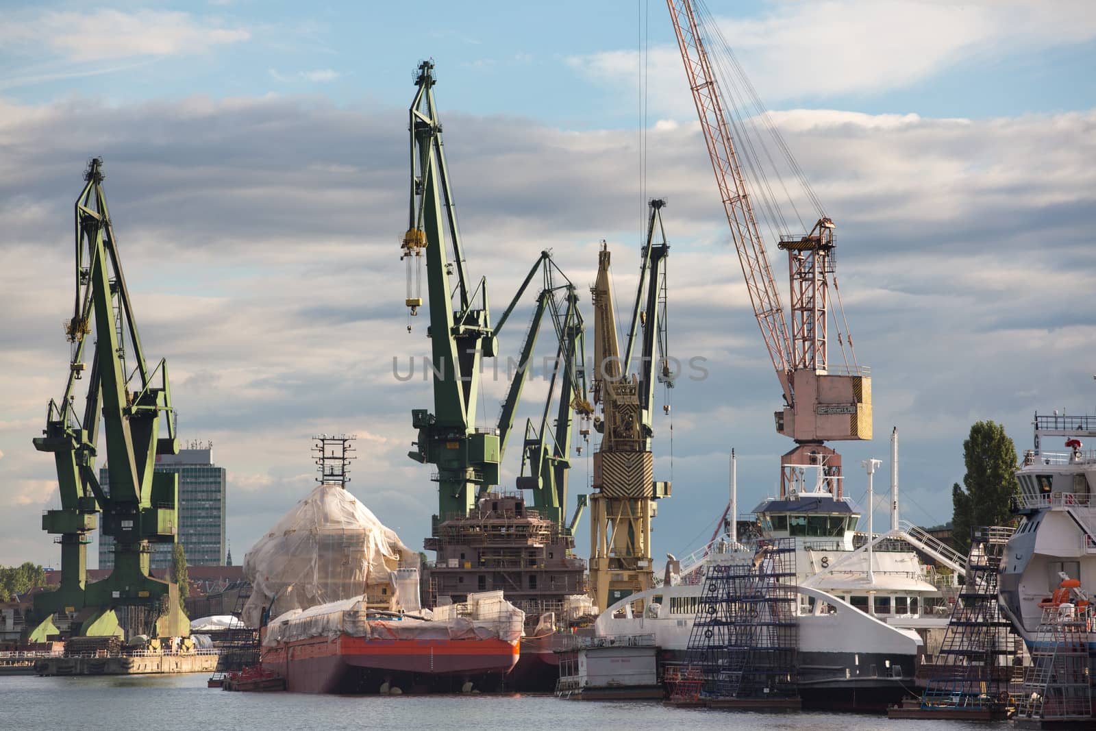 Huge ships with cranes in Gdansk Shipyard by watchtheworld