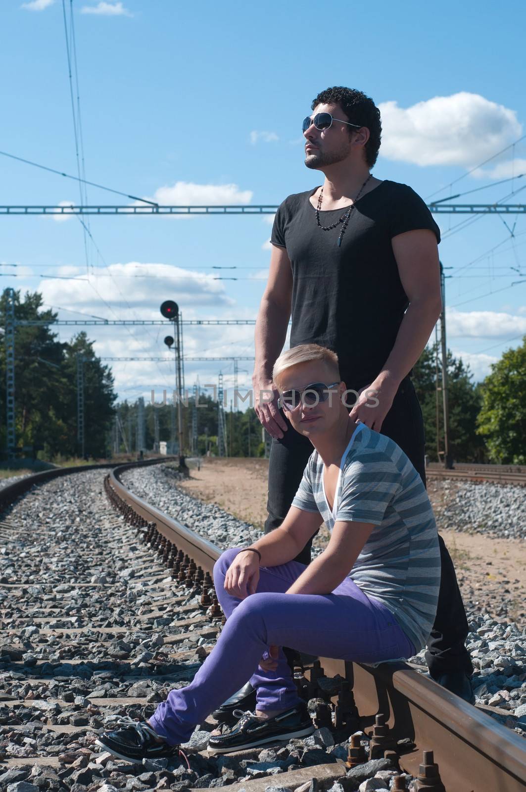 Shot of two young men on train tracks
