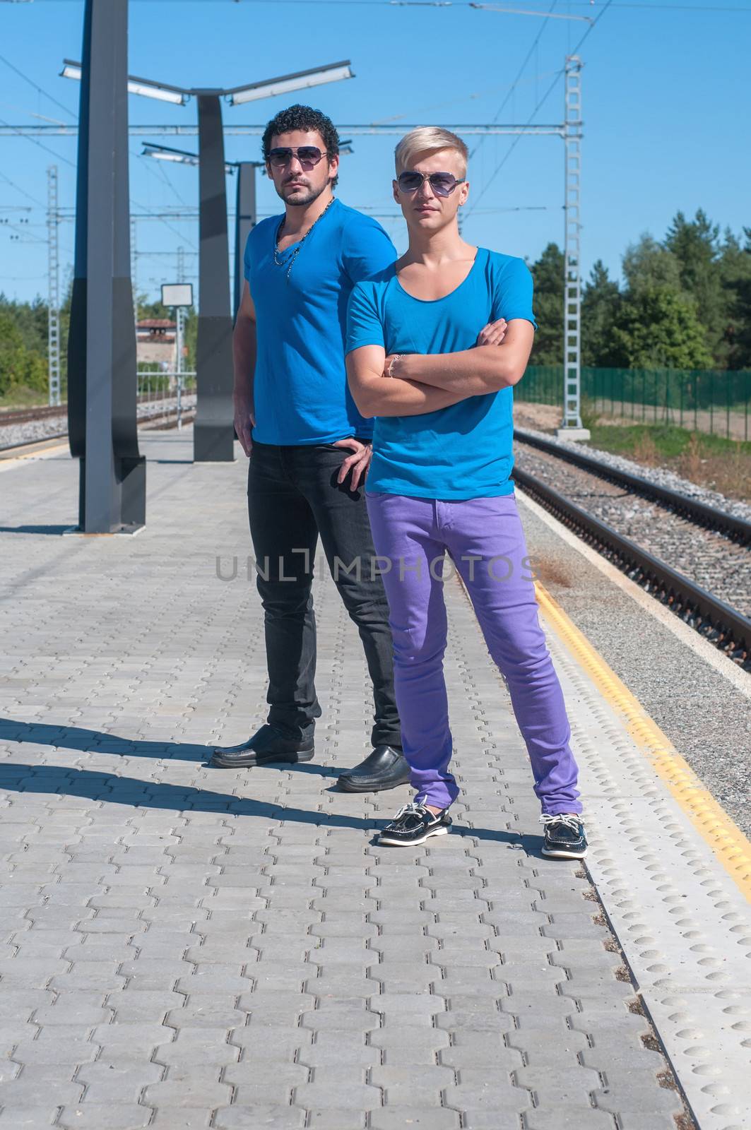 Shot of two young men standing on platform