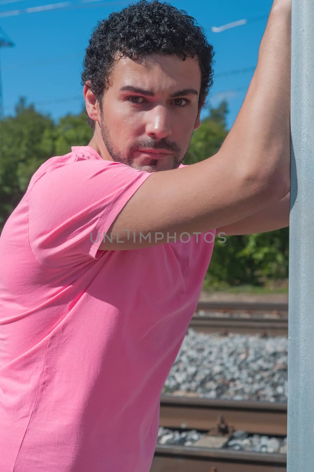 Handsome young man in pink t-shirt by anytka