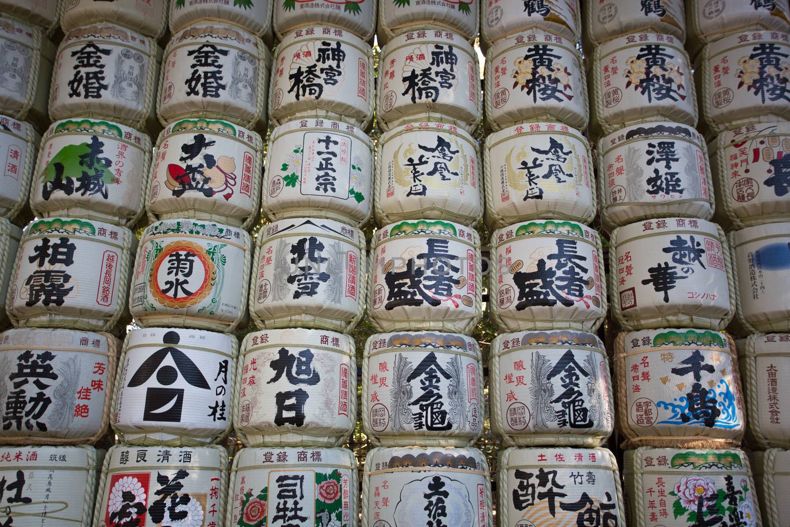 TOKYO, JAPAN - JANUARY 1, 2013: Sake barrels at Meiji Jingu Shrine in Tokyo.The barrels that decorate the entrance of shrines are called Kazaridaru. They are empty but have a strong spiritually significance as sake or rice wine has always been an instrument to bring humans closer to the gods.