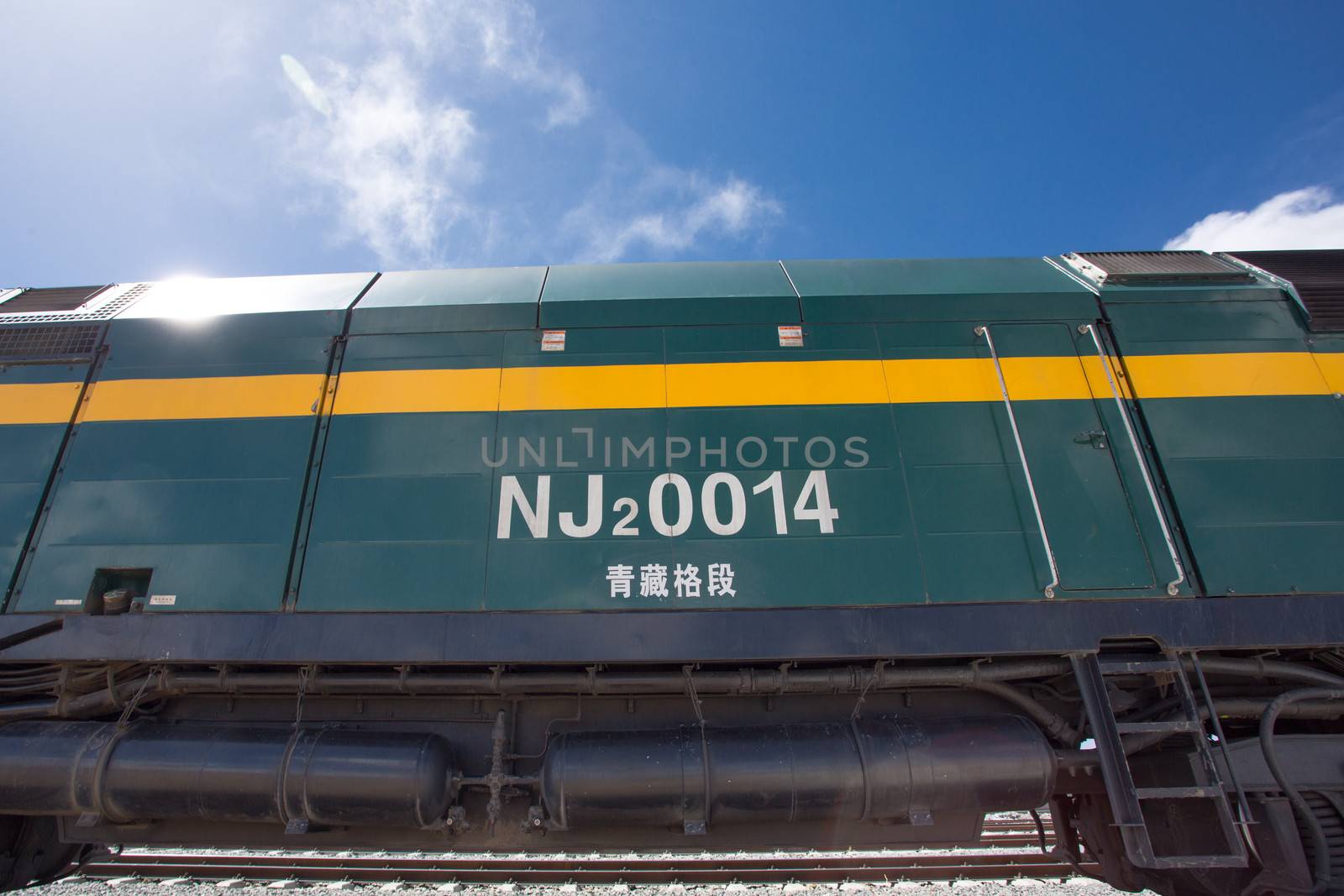 View of the locomotive of the Shanghai - Lhasa train stopped in a train station in Tibet. China 2013.