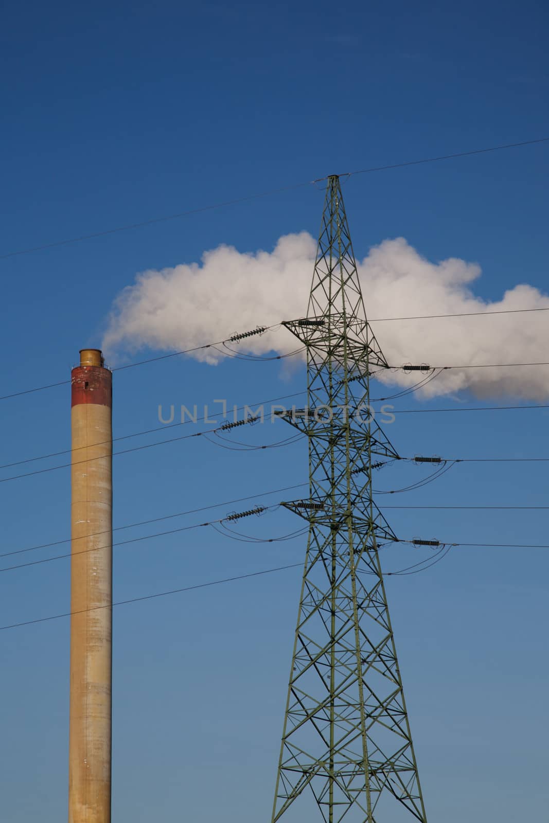 Incineration plant in Brussels, Belgium. Blue and clear sky with electrical wires.