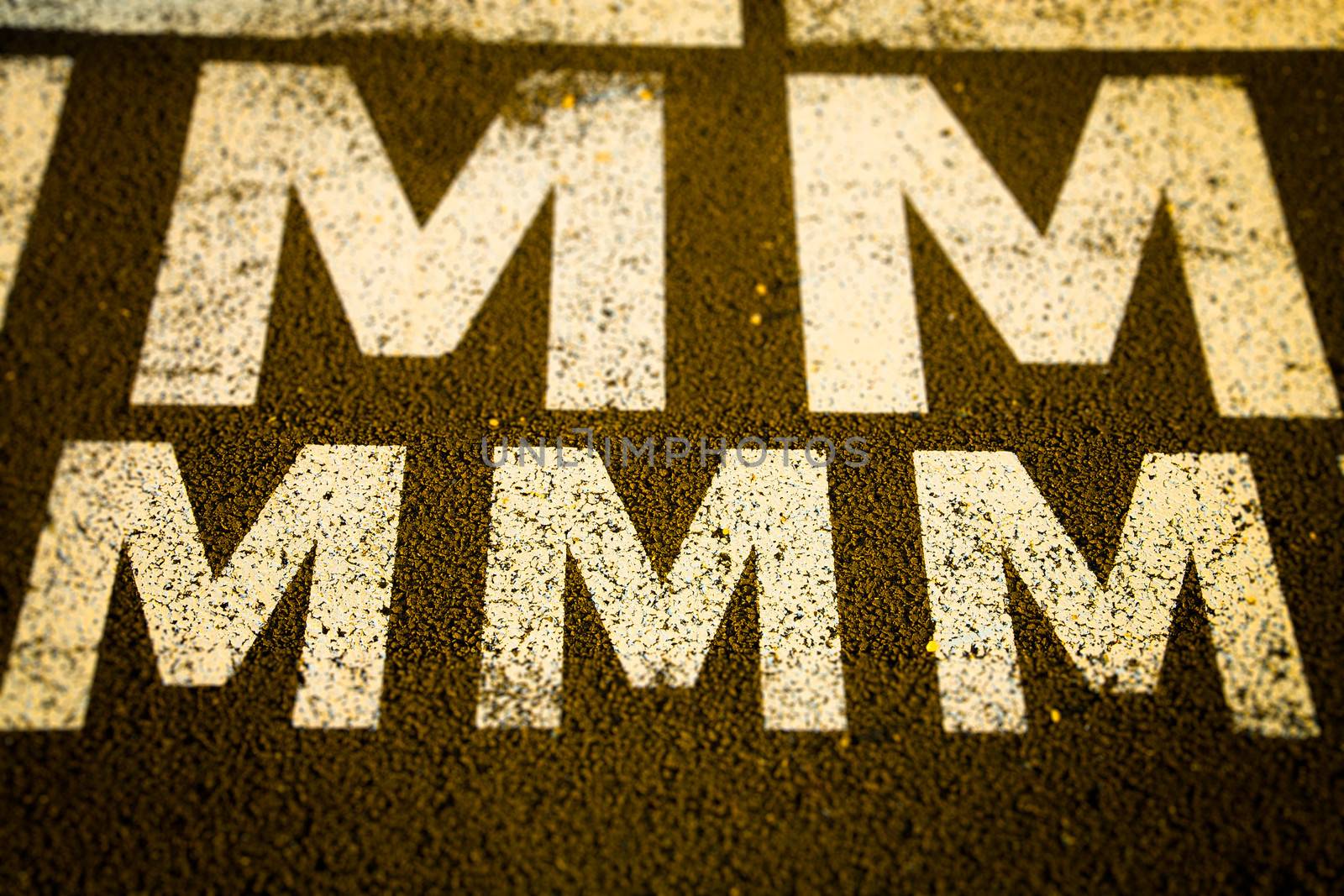 White letter m against a black toad in Lisboa, Portugal.