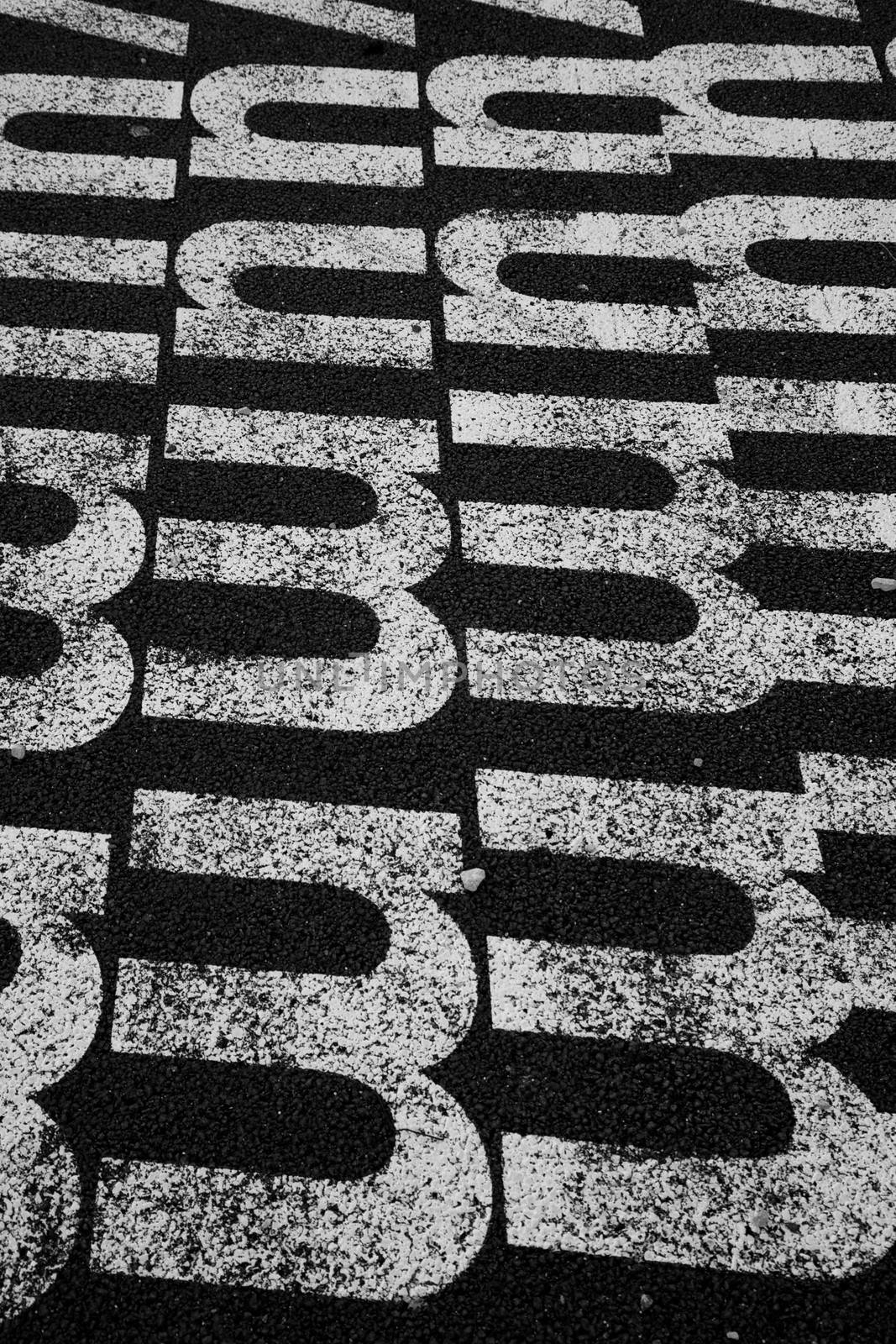 White letter m against a black toad in Lisboa, Portugal.