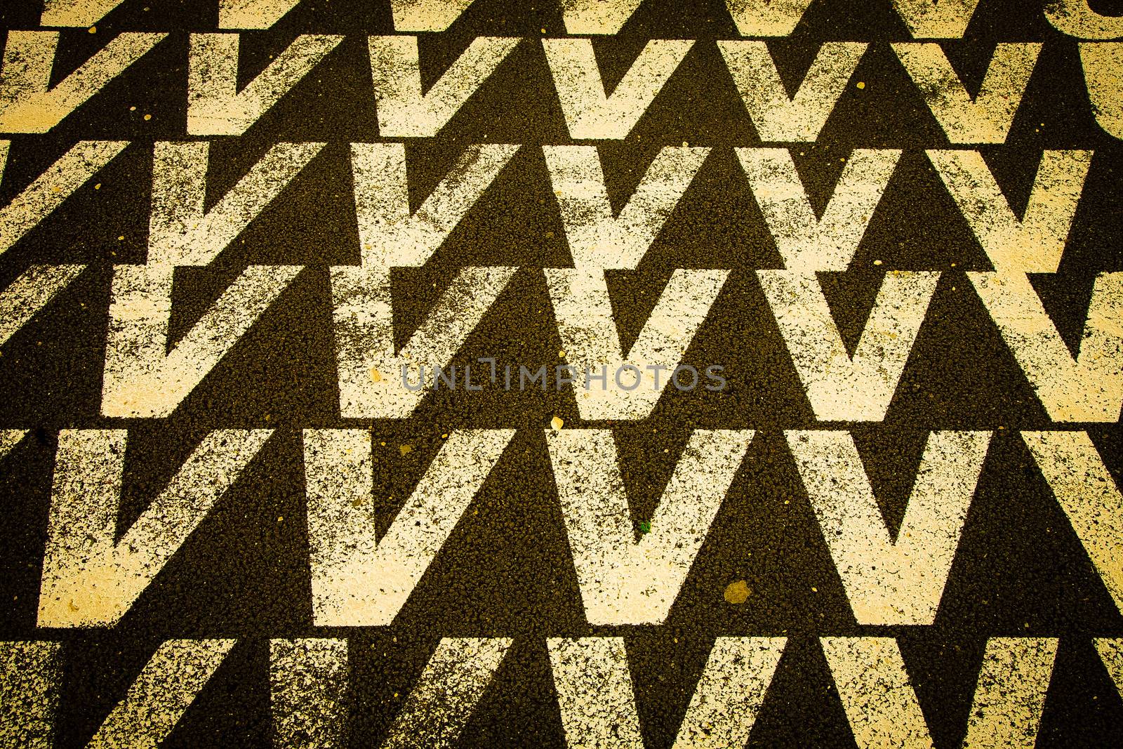 White letter v against a black toad in Lisboa, Portugal.